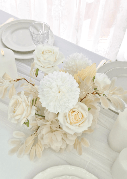 Artificial wedding table centrepiece, angled view of white faux blooms and green leaves. Made in Melbourne by Flowers For Ever After, shipping Australia and Worldwide.