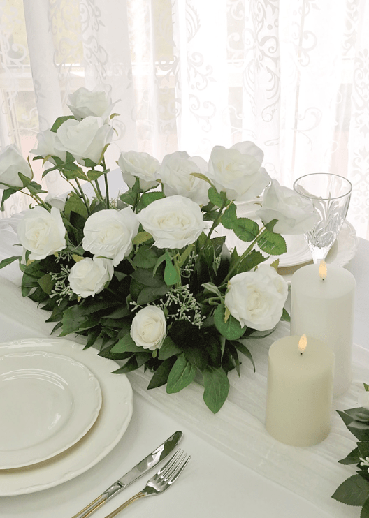 Artificial wedding table arrangement, angled view of clustered white faux blooms and green leaves. Made in Melbourne by Flowers For Ever After, shipping Australia and Worldwide.