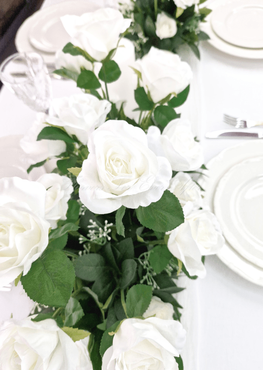 Artificial wedding floral arrangement close-up showing white faux flower petals and green foliage. Made in Melbourne by Flowers For Ever After, shipping Australia and Worldwide.