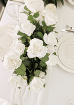 Artificial wedding table arrangement, overhead view of white faux blooms and green leaves. Made in Melbourne by Flowers For Ever After, shipping Australia and Worldwide.