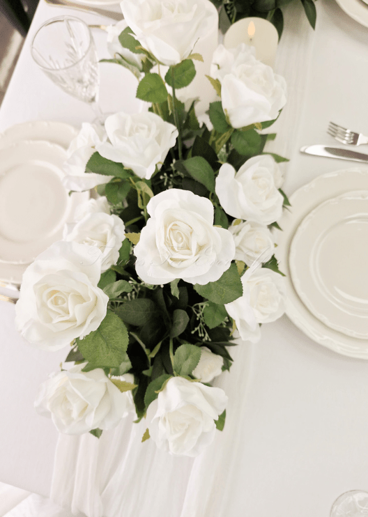 Artificial wedding table arrangement, overhead view of white faux blooms and green leaves. Made in Melbourne by Flowers For Ever After, shipping Australia and Worldwide.