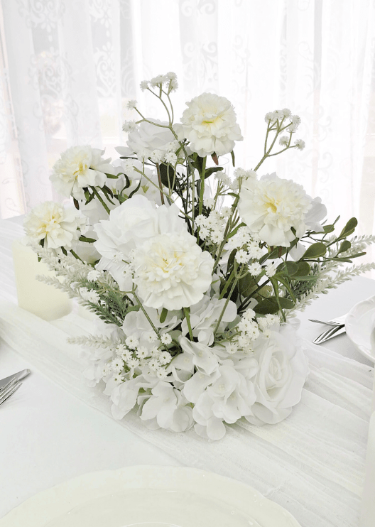 Artificial wedding table centrepiece with mixed faux flowers and green foliage in a low floral arrangement. Made in Melbourne by Flowers For Ever After, shipping Australia and Worldwide.