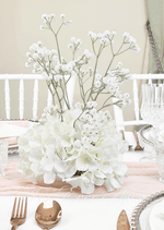 Artificial wedding table centrepiece with a rounded base of white faux hydrangea blooms and tall branching baby's breath. Made in Melbourne by Flowers For Ever After, shipping Australia and Worldwide.