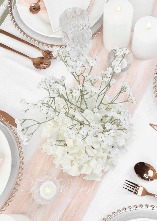 Artificial wedding table centrepiece, overhead view of white faux hydrangea blooms and branching baby's breath. Made in Melbourne by Flowers For Ever After, shipping Australia and Worldwide.