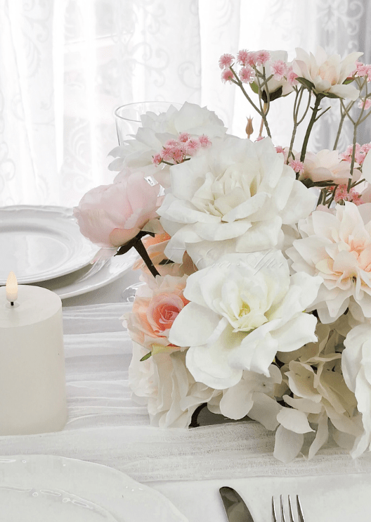 Artificial wedding table centrepiece close-up showing layered faux flower petals and green foliage. Made in Melbourne by Flowers For Ever After, shipping Australia and Worldwide.