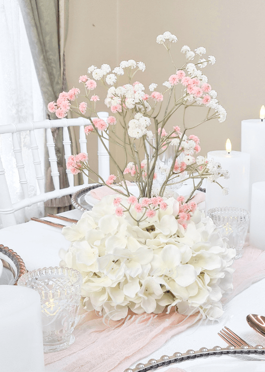 Artificial wedding table centrepiece with a rounded white faux hydrangea base and tall pink and white baby's breath sprigs. Made in Melbourne by Flowers For Ever After, shipping Australia and Worldwide.