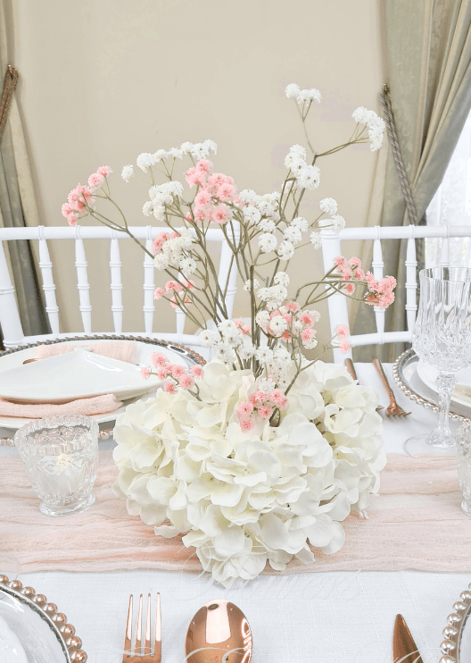 Artificial wedding table centrepiece, angled view of white faux hydrangea and tall pink and white baby's breath sprigs. Made in Melbourne by Flowers For Ever After, shipping Australia and Worldwide.