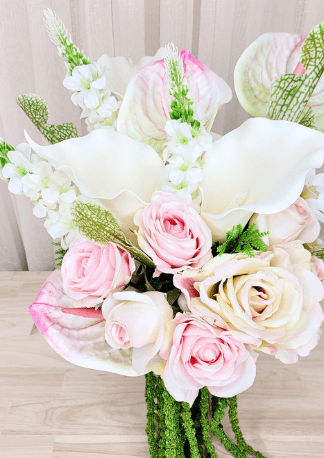 Artificial wedding bouquet detail with pink and ivory faux roses, white calla lilies, anthuriums and tall white flower spikes. Made in Melbourne by Flowers For Ever After, shipping Australia and Worldwide.