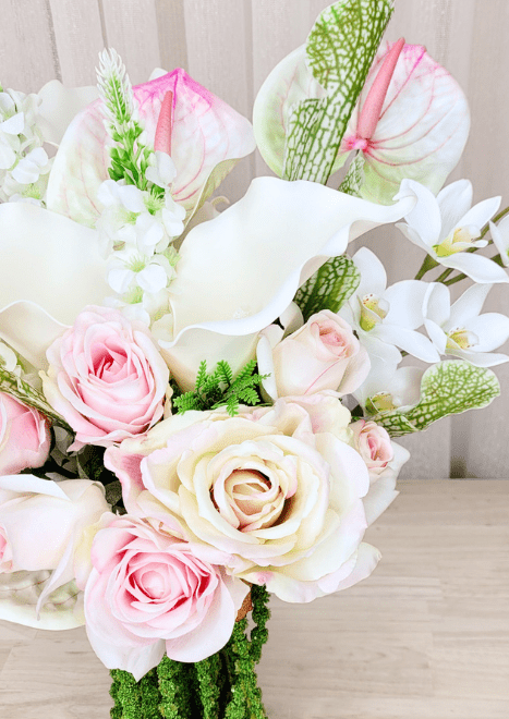 Artificial wedding bouquet close-up with pink and ivory faux roses, white calla lily, orchids and pink-streaked anthuriums. Made in Melbourne by Flowers For Ever After, shipping Australia and Worldwide.