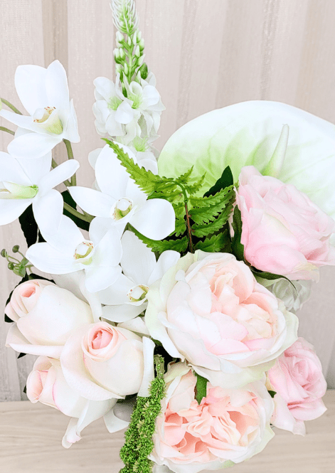 Artificial wedding bridesmaid bouquet close-up with pale pink faux roses and peony, white orchids, anthurium and fern-like leaves. Made in Melbourne by Flowers For Ever After, shipping Australia and Worldwide.