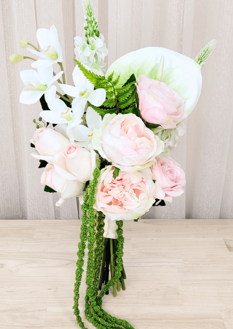 Artificial wedding bridesmaid bouquet with pink faux blooms, white orchids, white anthurium and long green trailing strands. Made in Melbourne by Flowers For Ever After, shipping Australia and Worldwide.