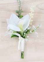 Artificial wedding boutonniere with white faux orchid, pale berry sprigs, curling green stem and white ribbon wrapping. For formals, proms and ball occasions. Made in Melbourne by Flowers For Ever After, shipping Australia and Worldwide.