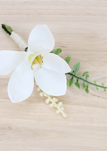 Artificial wedding boutonniere close-up with white faux orchid, pale berries and curled green sprig. For formals, proms and ball occasions. Made in Melbourne by Flowers For Ever After, shipping Australia and Worldwide.