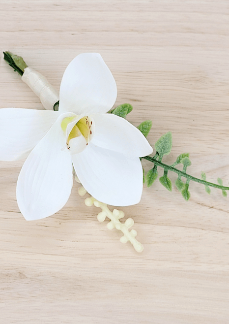 Artificial wedding boutonniere close-up with white faux orchid, pale berries and curled green sprig. For formals, proms and ball occasions. Made in Melbourne by Flowers For Ever After, shipping Australia and Worldwide.