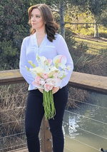 Artificial wedding bouquet held by a person, with pink and white faux blooms, white anthuriums and long green trailing strands. Made in Melbourne by Flowers For Ever After, shipping Australia and Worldwide.