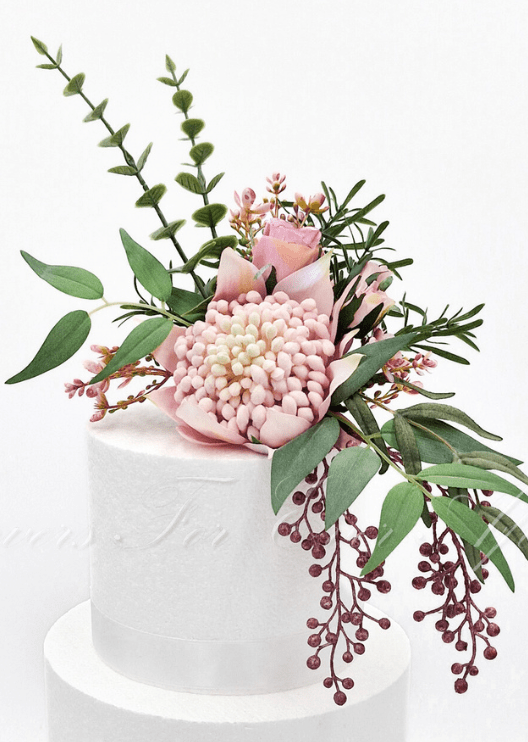 Artificial wedding cake decoration, angled view of pink faux waratah and green foliage. For birthday, event and celebration cakes. Made in Melbourne by Flowers For Ever After, shipping Australia and Worldwide.