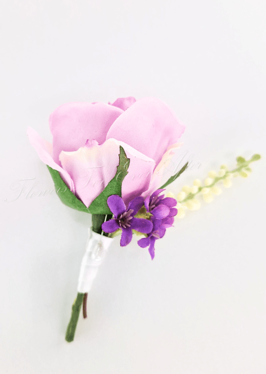 Artificial wedding boutonniere, angled view of a pink faux rose with small purple flowers and a pale spike. For formals, proms and ball occasions. Made in Melbourne by Flowers For Ever After, shipping Australia and Worldwide.