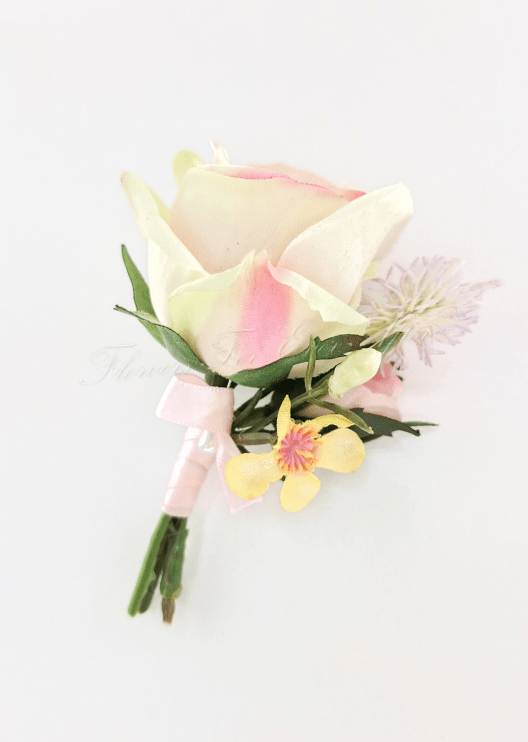 Artificial wedding boutonniere with a cream-and-pink faux rose, tiny yellow flowers, pale sprigs and a pink-wrapped stem. For formals, proms and ball occasions. Made in Melbourne by Flowers For Ever After, shipping Australia and Worldwide.