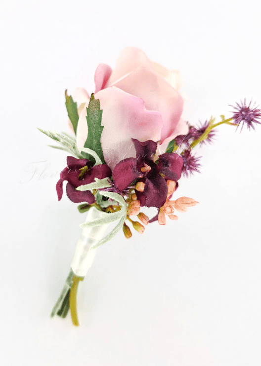 Artificial wedding boutonniere, side view of a blush faux rose, burgundy flowers, purple sprigs and grey-green foliage. For formals, proms and ball occasions. Made in Melbourne by Flowers For Ever After, shipping Australia and Worldwide.
