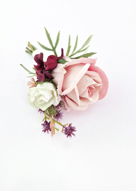 Artificial wedding boutonniere, top view of a blush faux rose, small white rosebud, burgundy flowers and purple sprigs. For formals, proms and ball occasions. Made in Melbourne by Flowers For Ever After, shipping Australia and Worldwide.