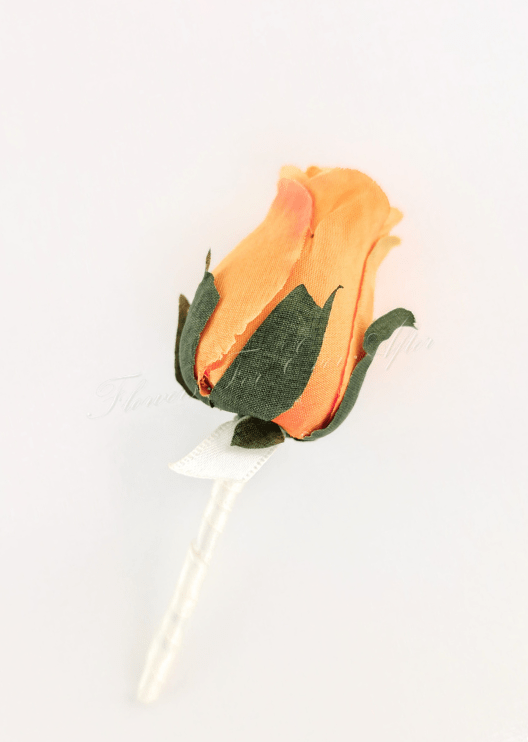 Artificial wedding boutonniere with an orange faux rosebud, green sepals and an ivory-wrapped stem, side view. For formals, proms and ball occasions. Made in Melbourne by Flowers For Ever After, shipping Australia and Worldwide.