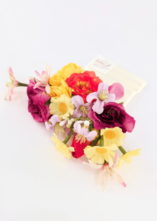 Artificial wedding pocket corsage close-up with magenta and orange faux roses, yellow daisies and pale pink blossoms. For formals, proms and ball occasions. Made in Melbourne by Flowers For Ever After, shipping Australia and Worldwide.