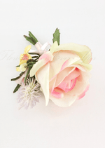 Artificial wedding boutonniere, top view of a cream-and-pink faux rose, tiny yellow flowers and pale sprigs. For formals, proms and ball occasions. Made in Melbourne by Flowers For Ever After, shipping Australia and Worldwide.