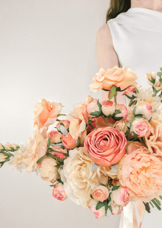Artificial wedding bridesmaid bouquet with mixed faux blooms, green foliage and a wrapped handle. Made in Melbourne by Flowers For Ever After, shipping Australia and Worldwide.