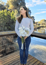 Artificial wedding bouquet held by a person, with white faux anthuriums and blooms, trailing green berries and long ribbons. Made in Melbourne by Flowers For Ever After, shipping Australia and Worldwide.