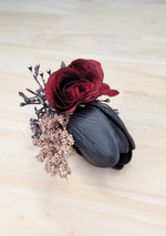 Artificial wedding boutonniere close-up with burgundy faux rose, black tulip, mauve sprigs and dark berries. For formals, proms and ball occasions. Made in Melbourne by Flowers For Ever After, shipping Australia and Worldwide.