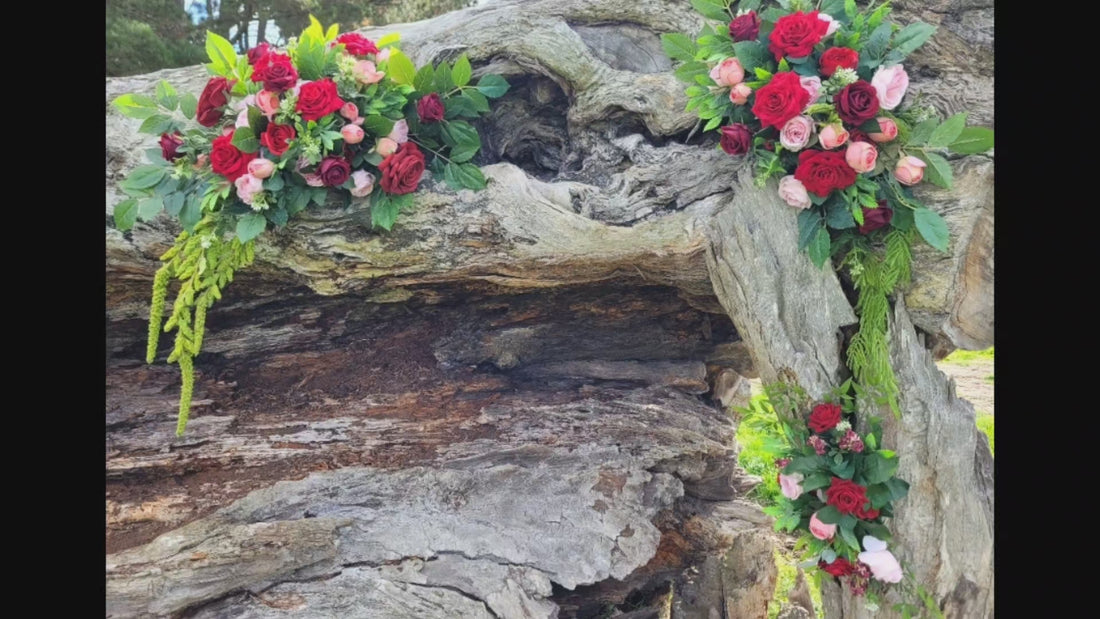 Silk wedding arbour flowers in pink red and foliage. By Flowers For Ever After made in Melbourne