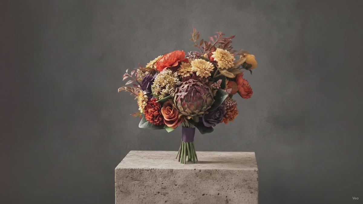A rustic orange and purple autumn toned faux flower wedding bouquet. Flowers by Flowers For Ever After