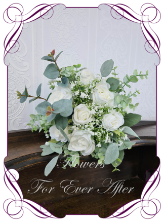 A Gorgeous Silk Artificial white roses and Baby's Breath Bridal Bouquet posy, featuring faux flowers Australian native blue gum leaves in a romantic elegant and unusual bridal style, classic white wedding flowers, native rustic wedding, boho flowers, traditional wedding bouquets. Made in Melbourne by Australia's Best Artificial Bridal Florist. Worldwide Shipping available