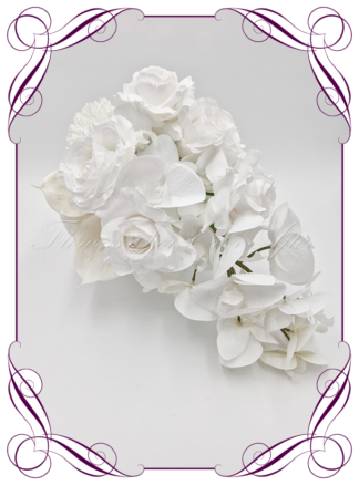 Artificial Bridal tear cascade flowers in white pom poms, roses, orchids, anthurium. Silk wedding Bouquet posy, featuring faux flowers in a romantic elegant and unusual bridal style, classic white and traditional wedding bouquets. Made in Melbourne by Australia's Best Artificial Bridal Florist. Buy now Online. Worldwide Shipping available