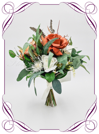 Silk Bridal Bouquet in realistic rust burnt orange, green leaves, and ivory, native faux flowers. Bridal posy, featuring artificial roses, bottle brush, banksia, peony, king protea flowers in a romantic rustic and unusual bridal style modern rustic wedding bouquets. Made in Melbourne by Australia's Best Artificial Bridal Florist. Buy online now. Worldwide Shipping available